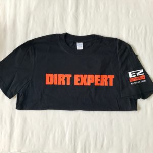 A shirt that says Dirt Expert on it.